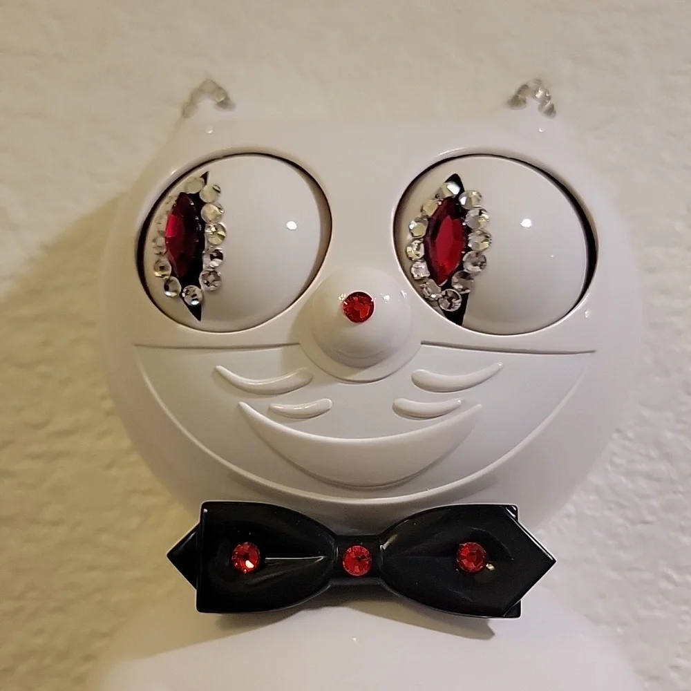 Jeweled White Kit-Cat Klock clock with black bow tie and tail
